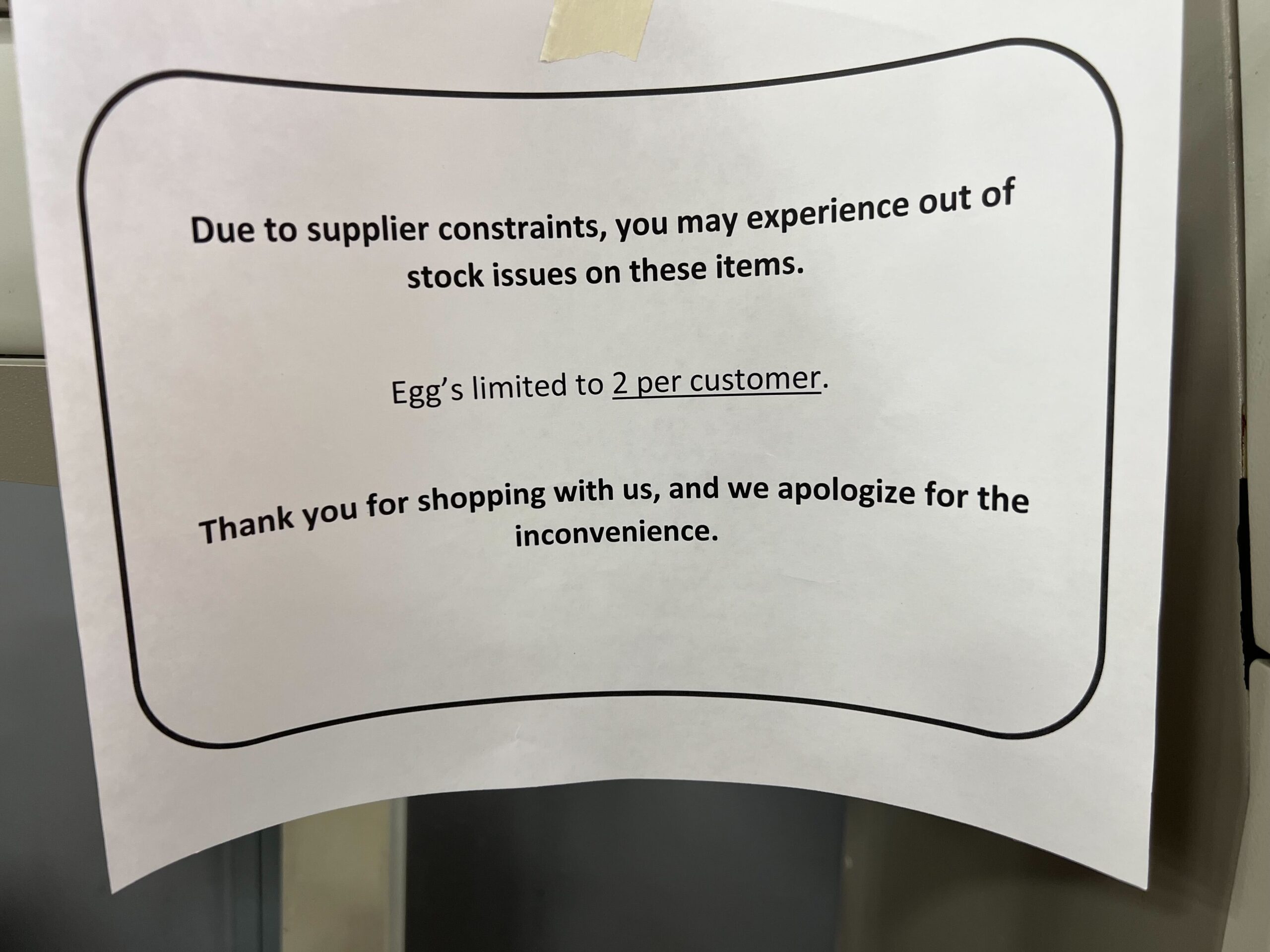 A sign says customers can only buy 2 egg cartons