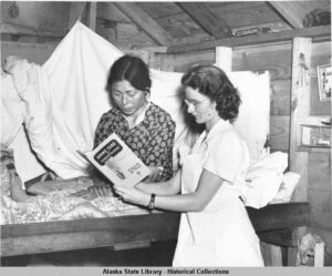 two 1940s nurses reading a tuberculosis manual