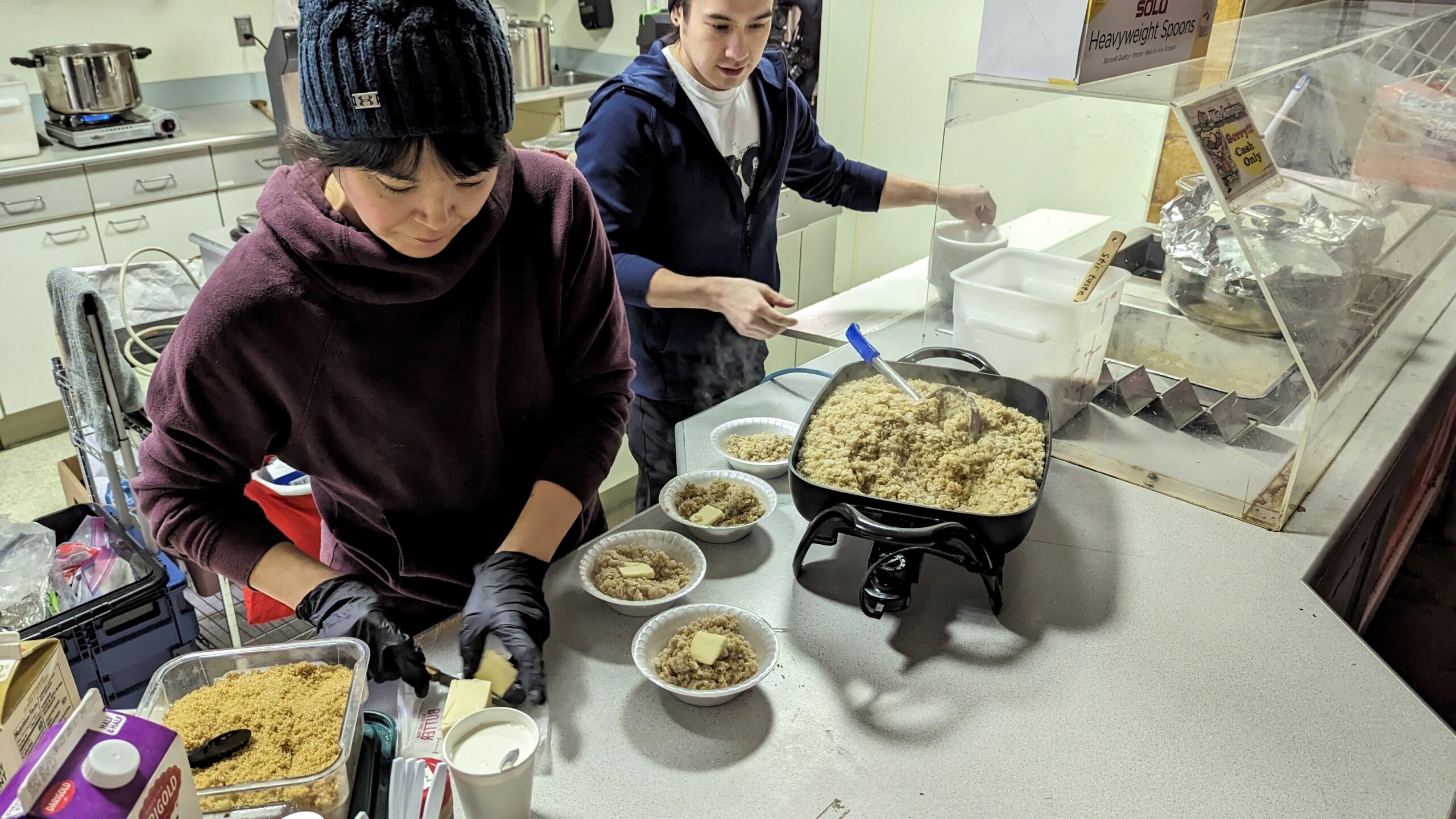 volunteers dish up hot oatmeal