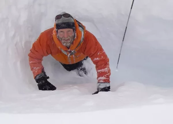 National Parks Service glaciologist Mike Loso measuring snowpack depth