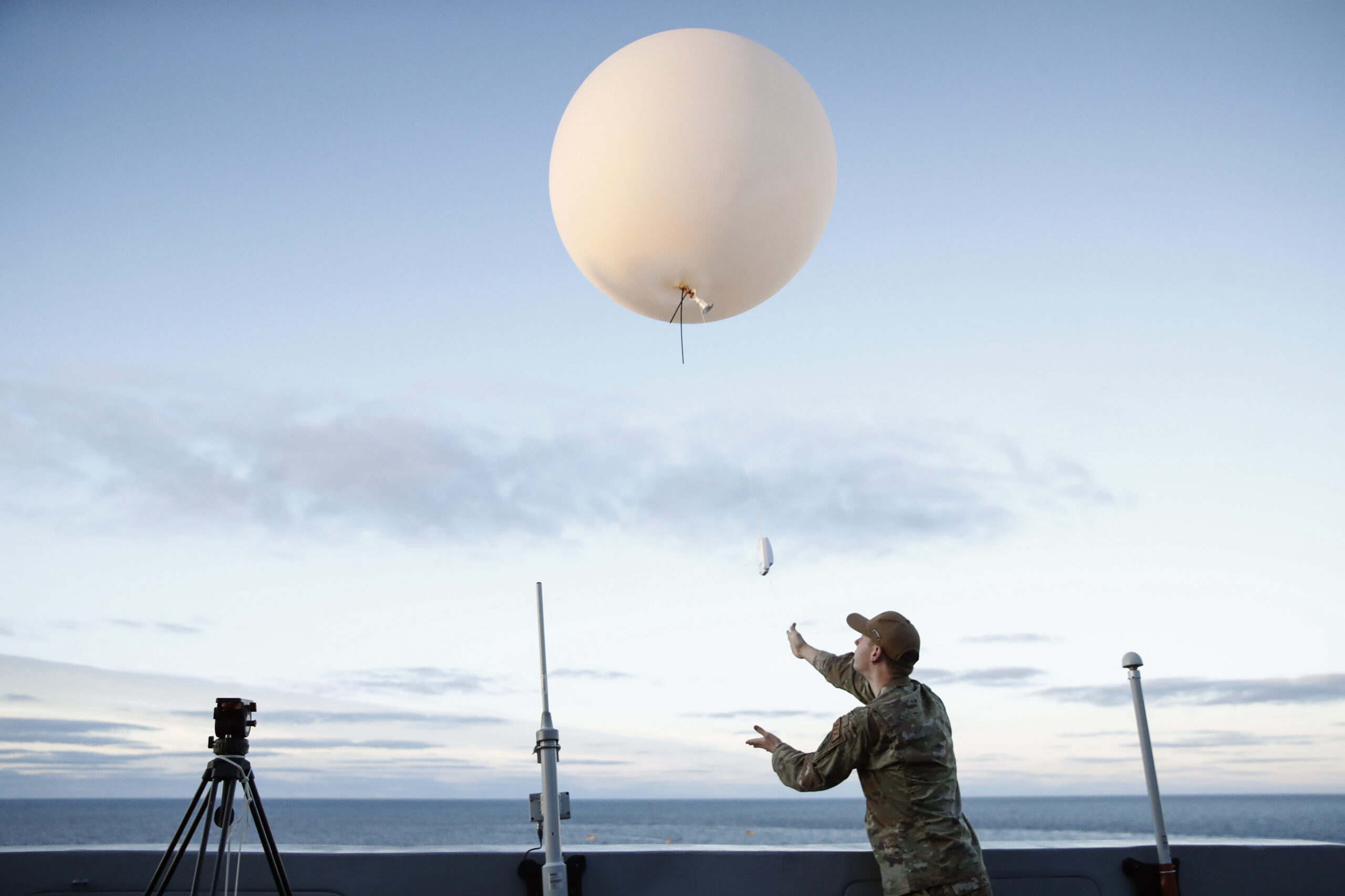 a person launches a big white balloon 