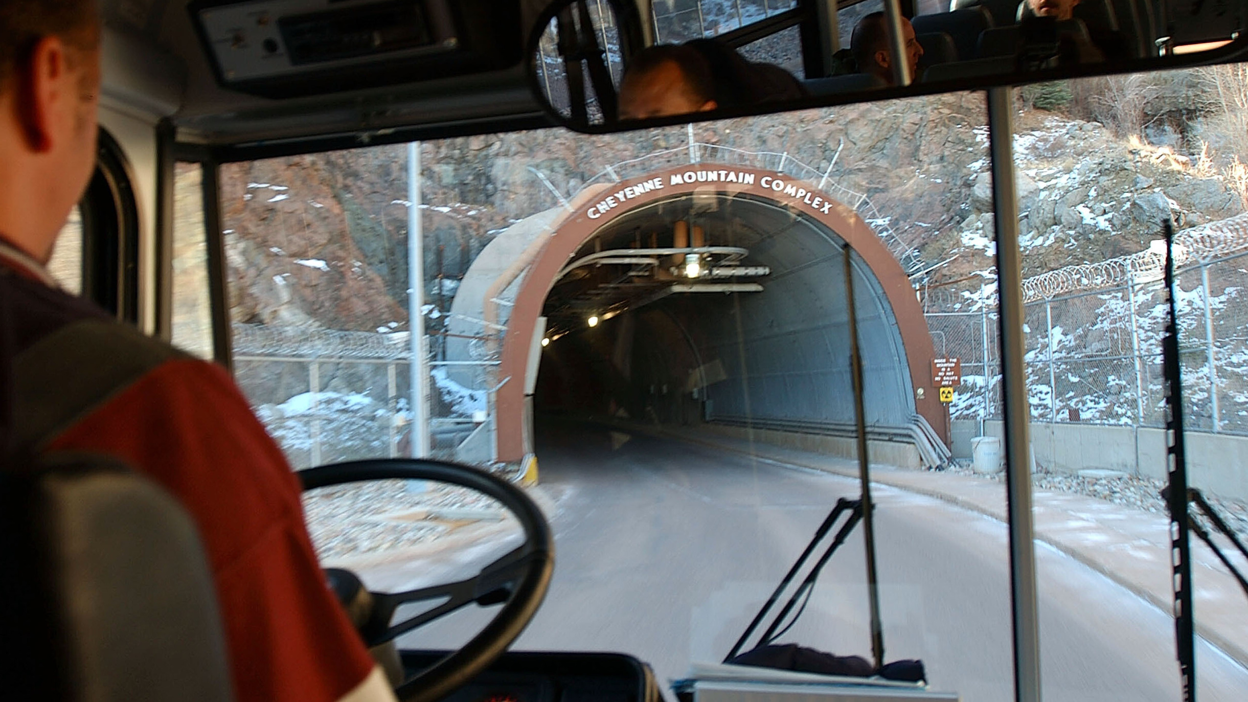 a person behind a wheel driving into a tunnel