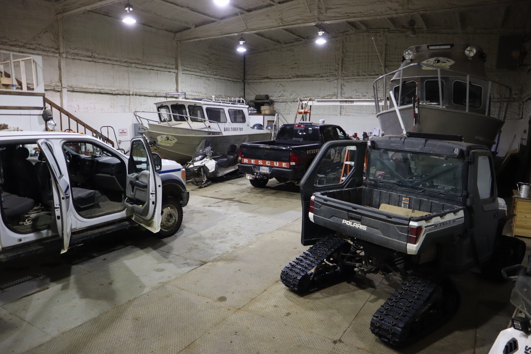 vehicles and a boat in a garage