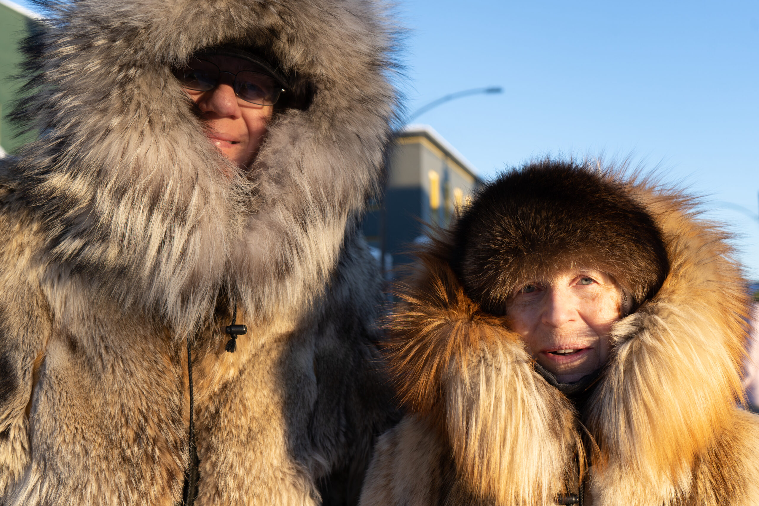 A man and a woman in fur jackets