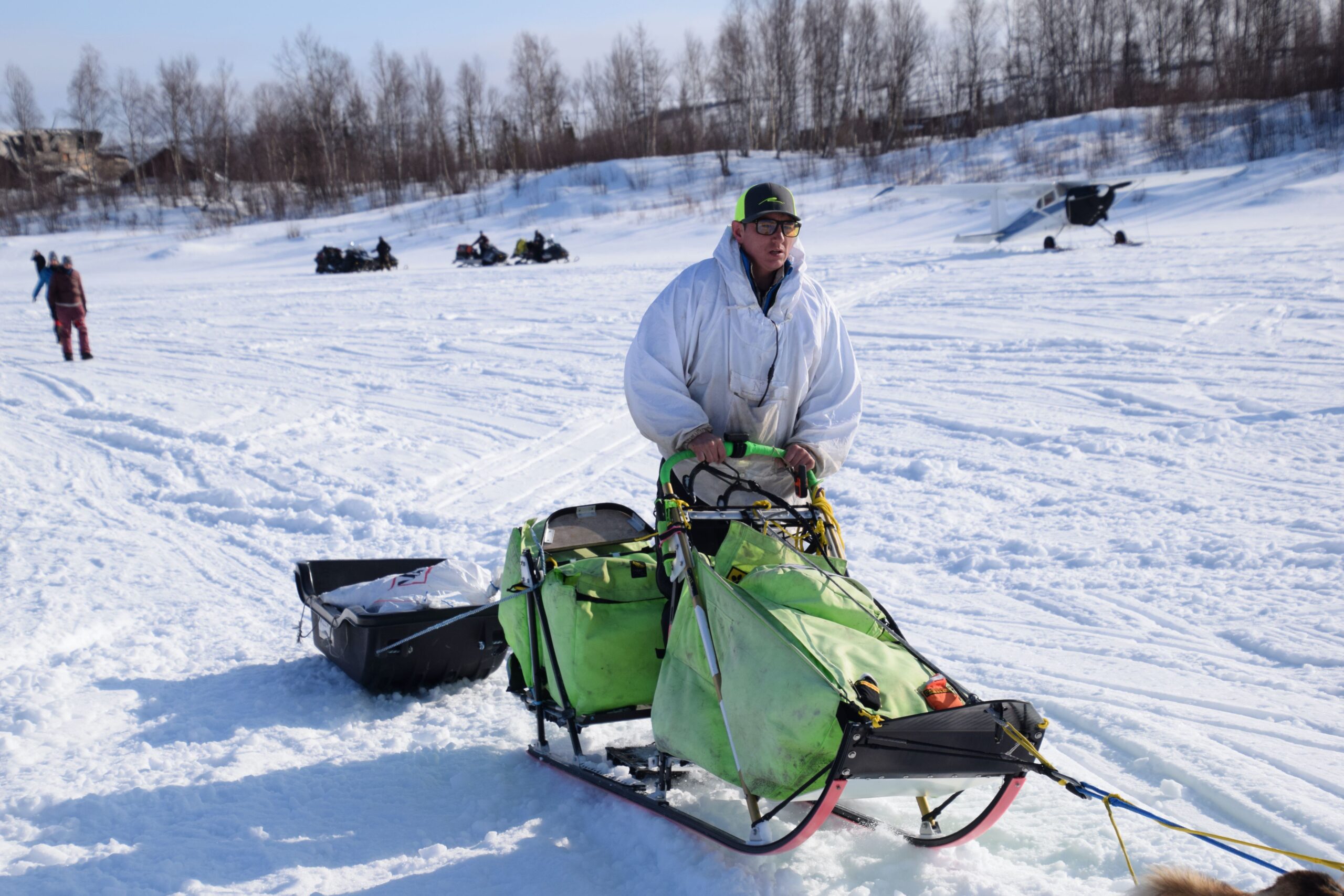 a musher on a sled