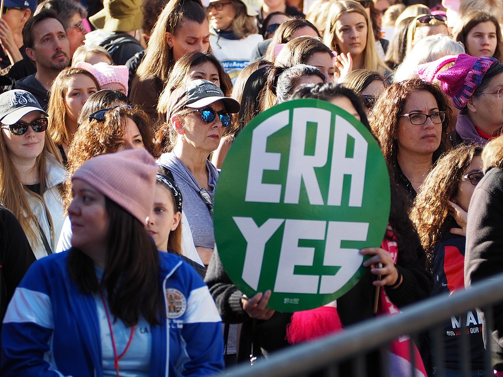 women hold an era yes sign