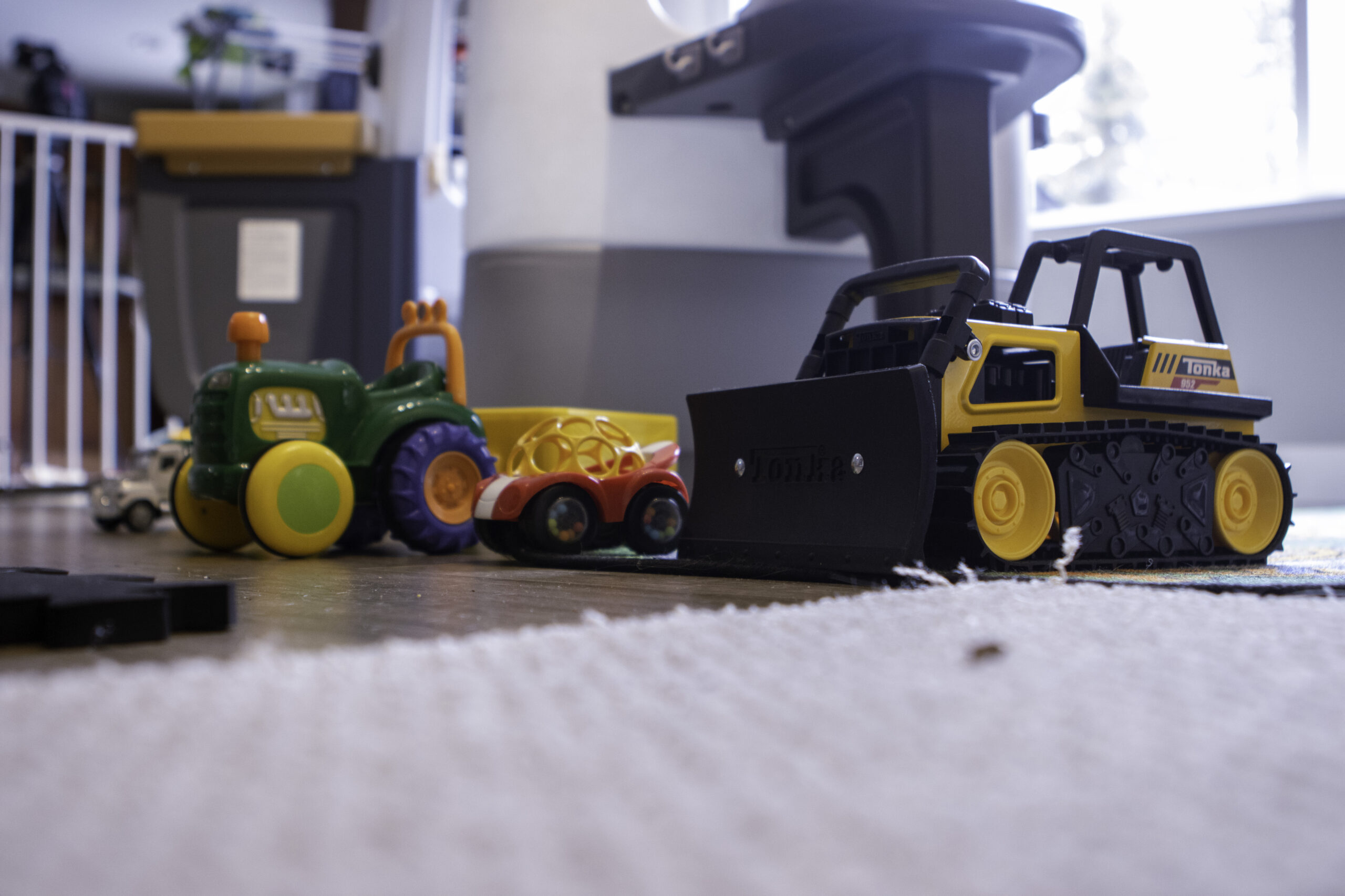 a line of toy cars and trucks on the ground
