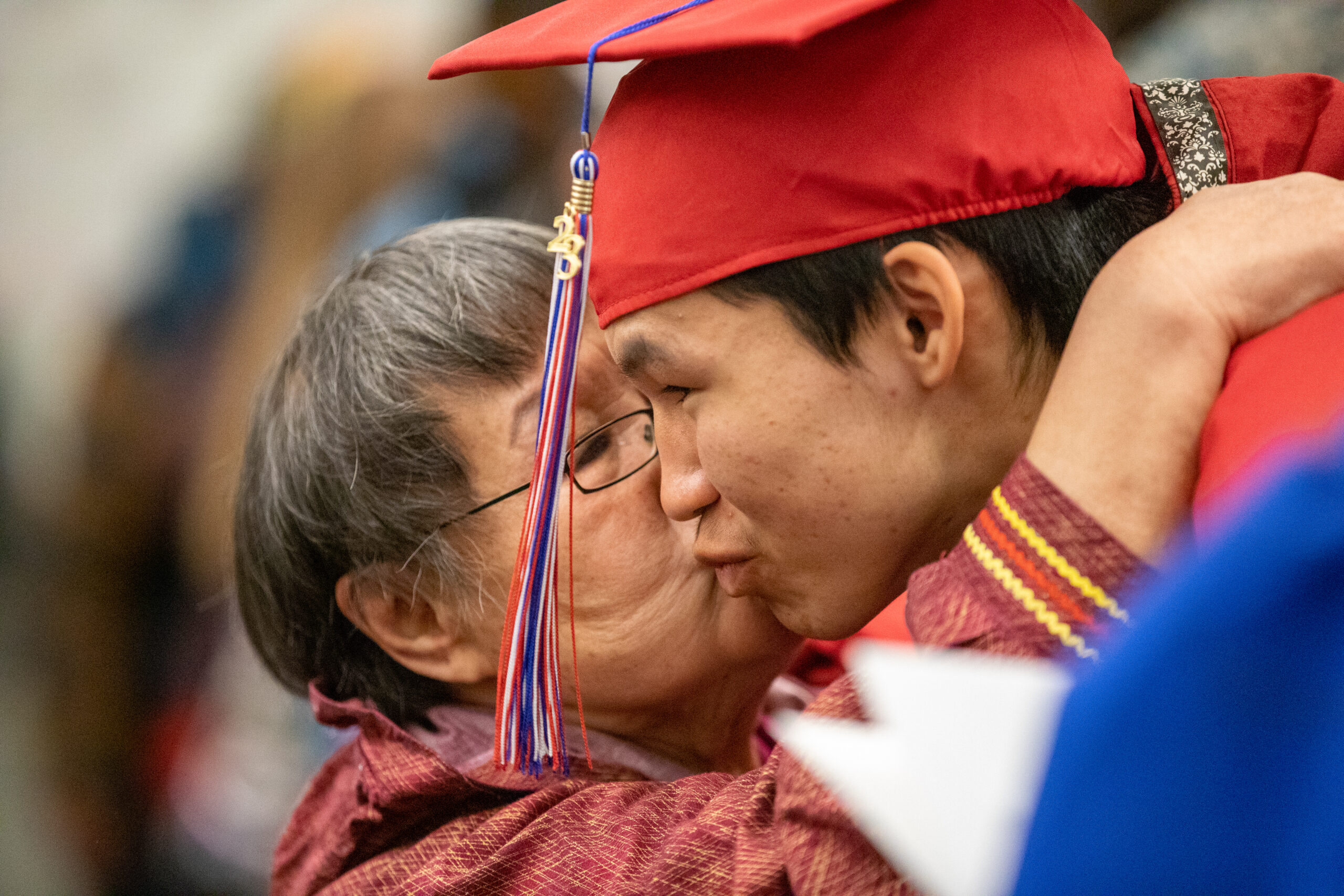 A high school graduate gets a kiss from a Yup'ik elder.