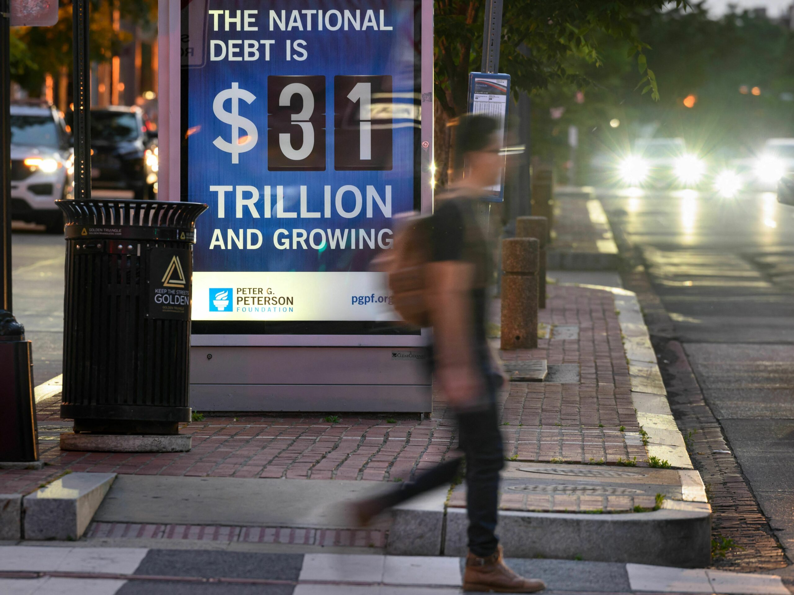 a sign says the national debt is $31 trillion and growing