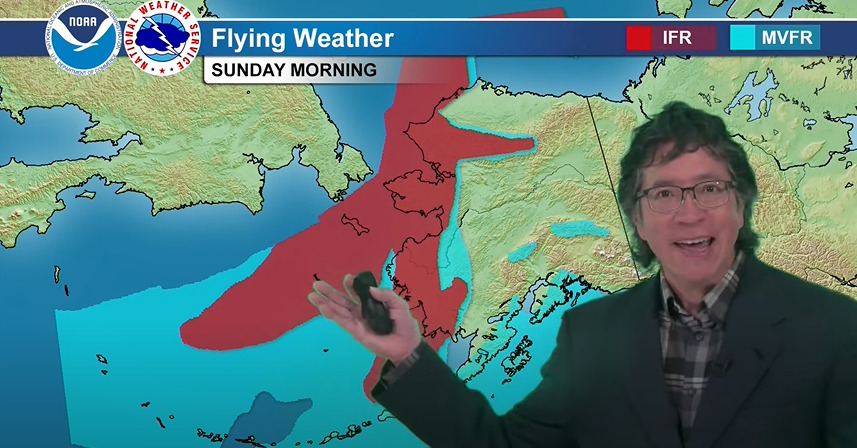 a man in front of a weather map