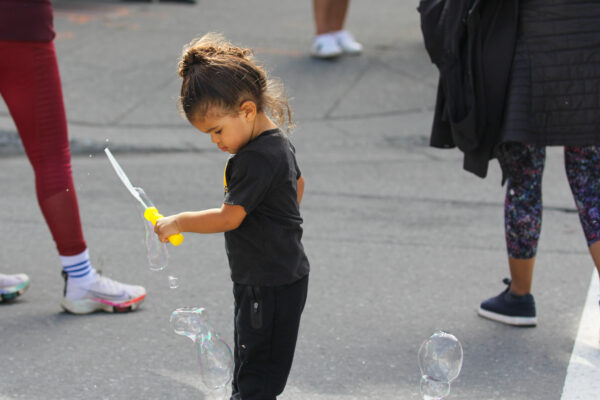 A young child plays with bubbles.