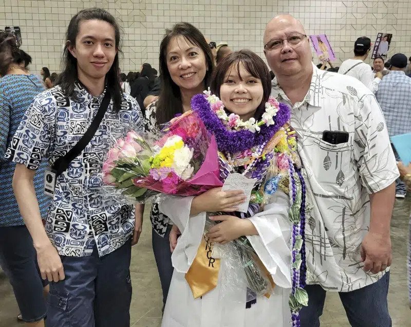 a family poses for a photo at a graduation