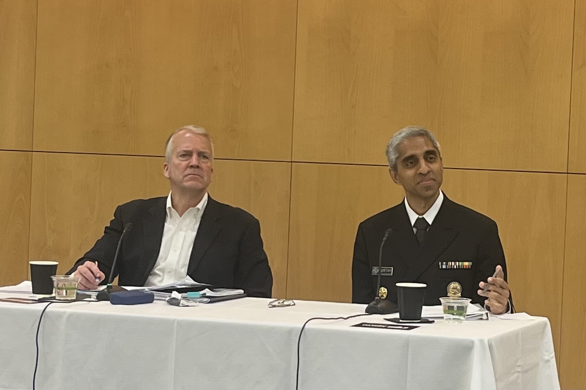 Sen. Dan Sullivan and U.S. Surgen General Vivek Murthy sit at a table.