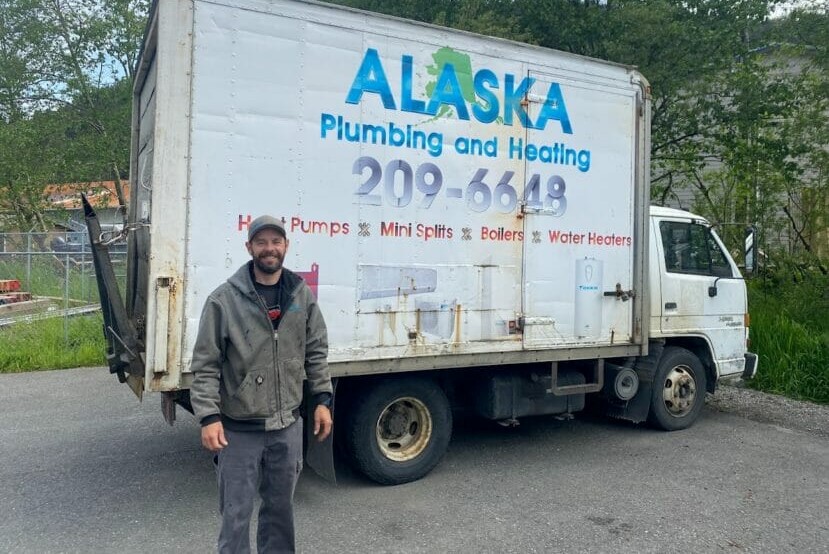 a person stands in front of a truck