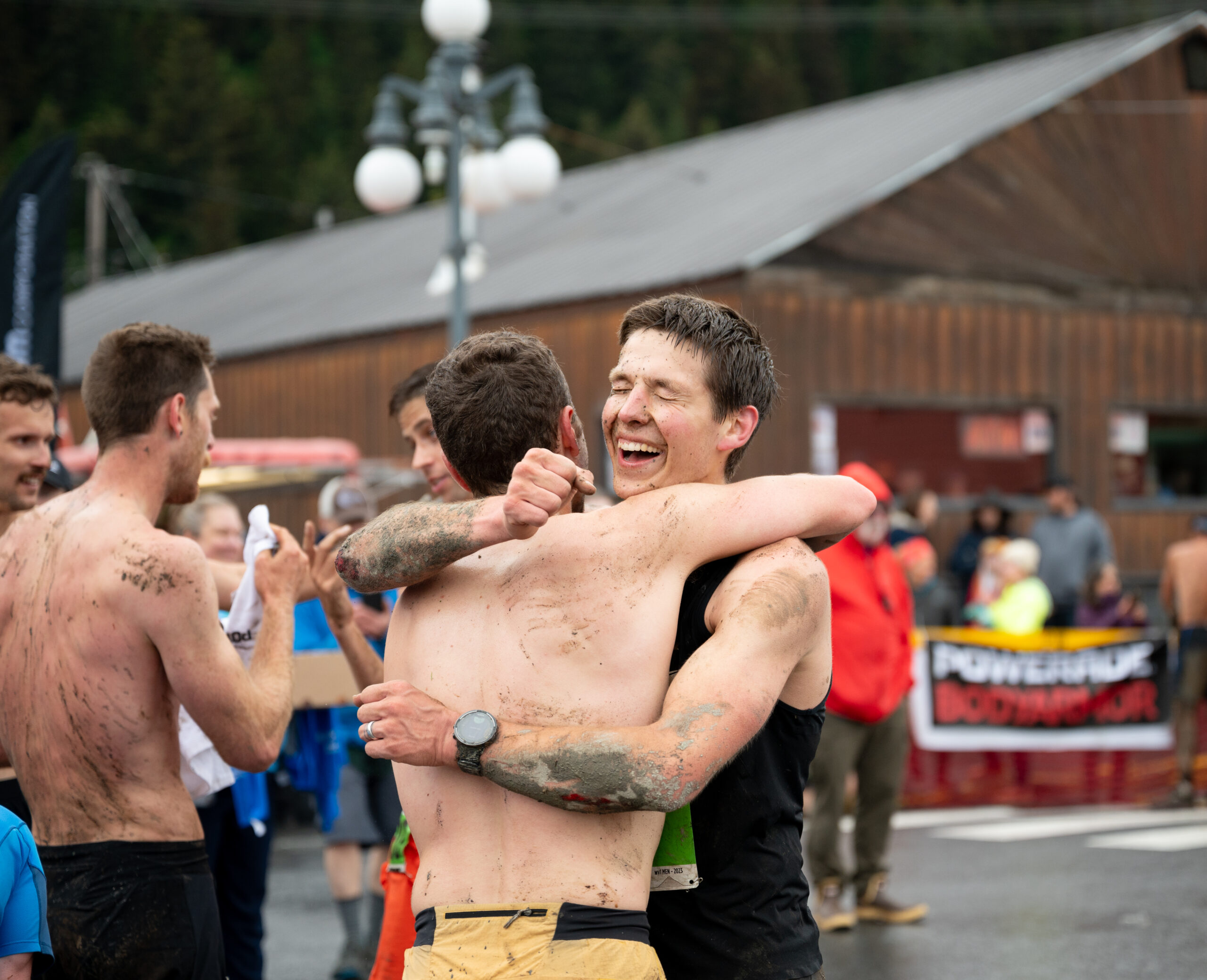 two men hug at a race finish line