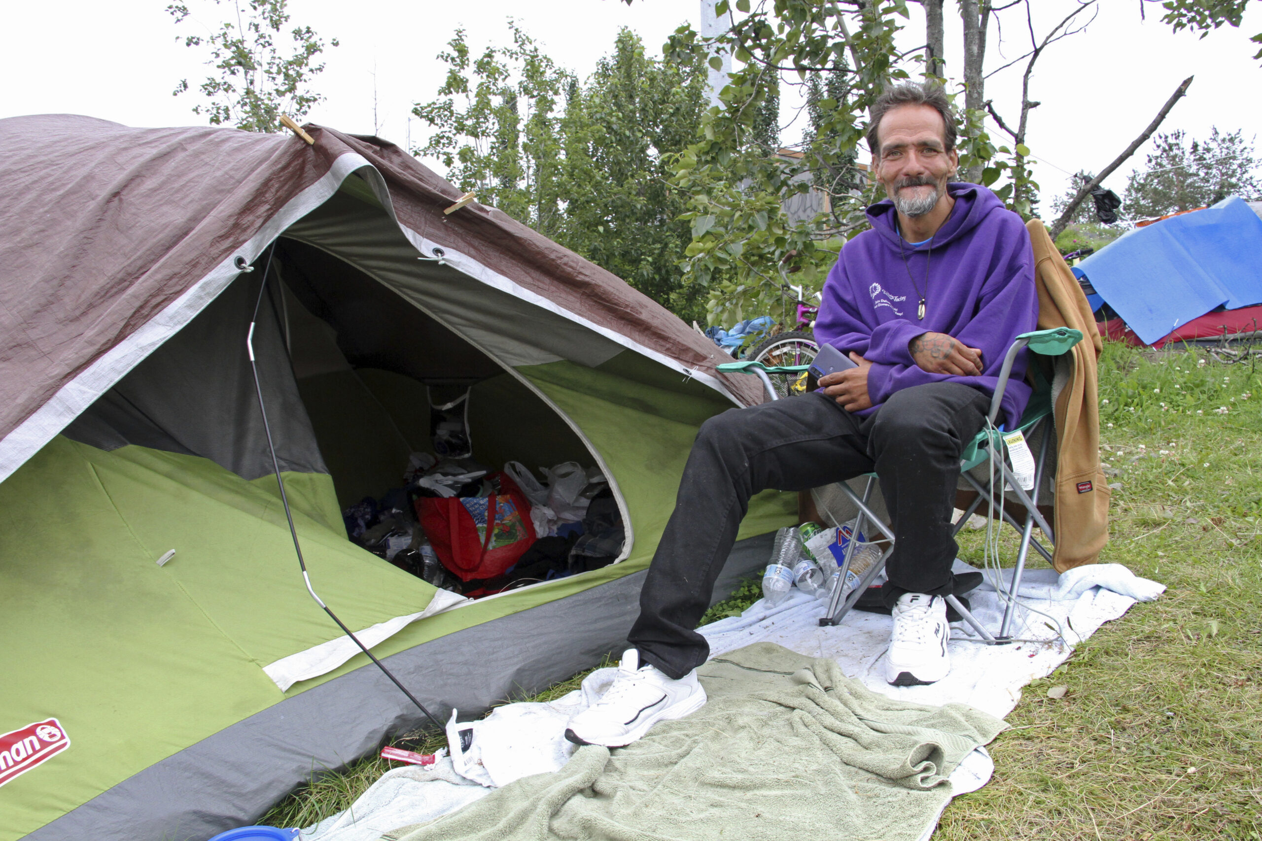 a man next to a tent