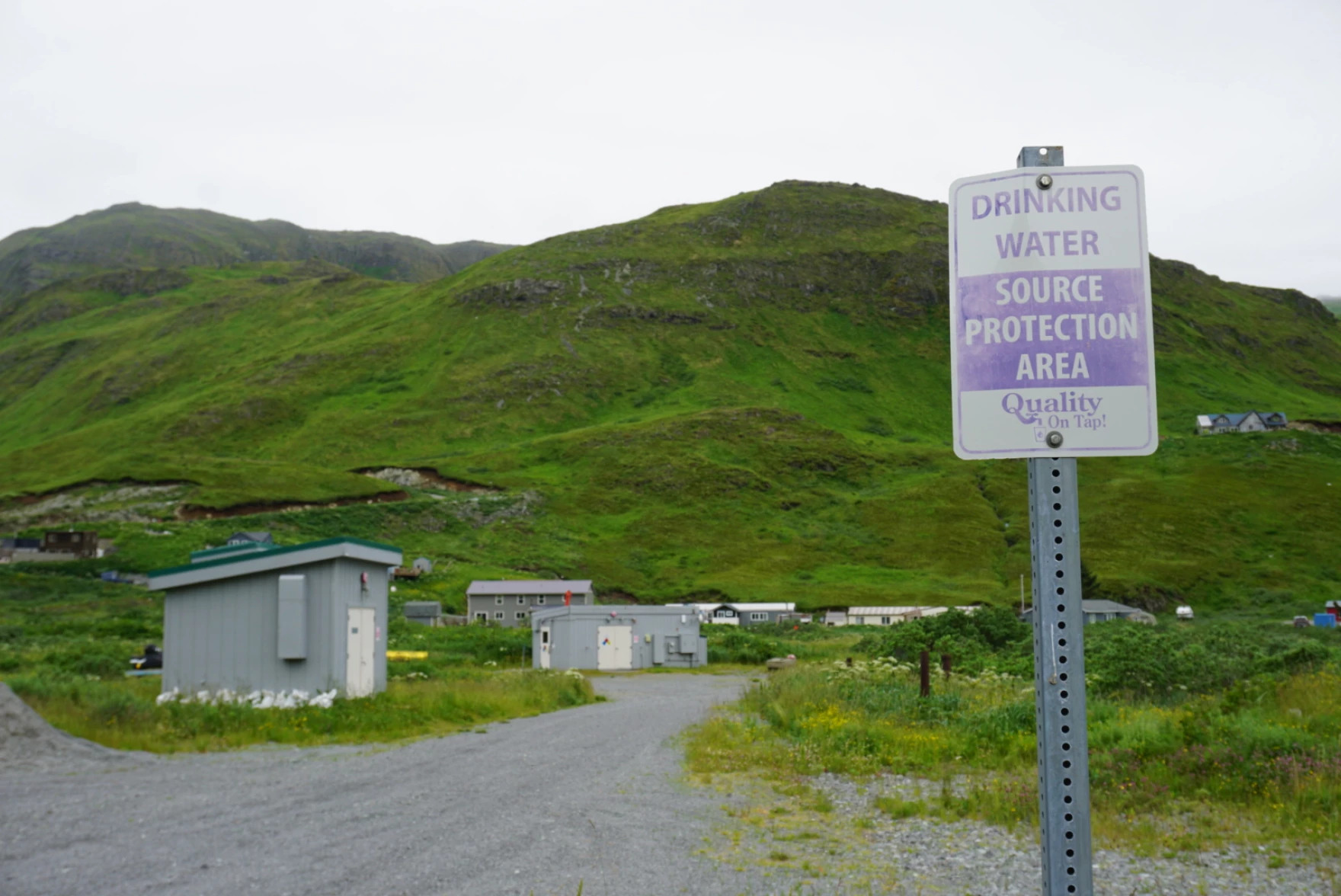an landscape photo with a sign that says "drinking water source protection area"