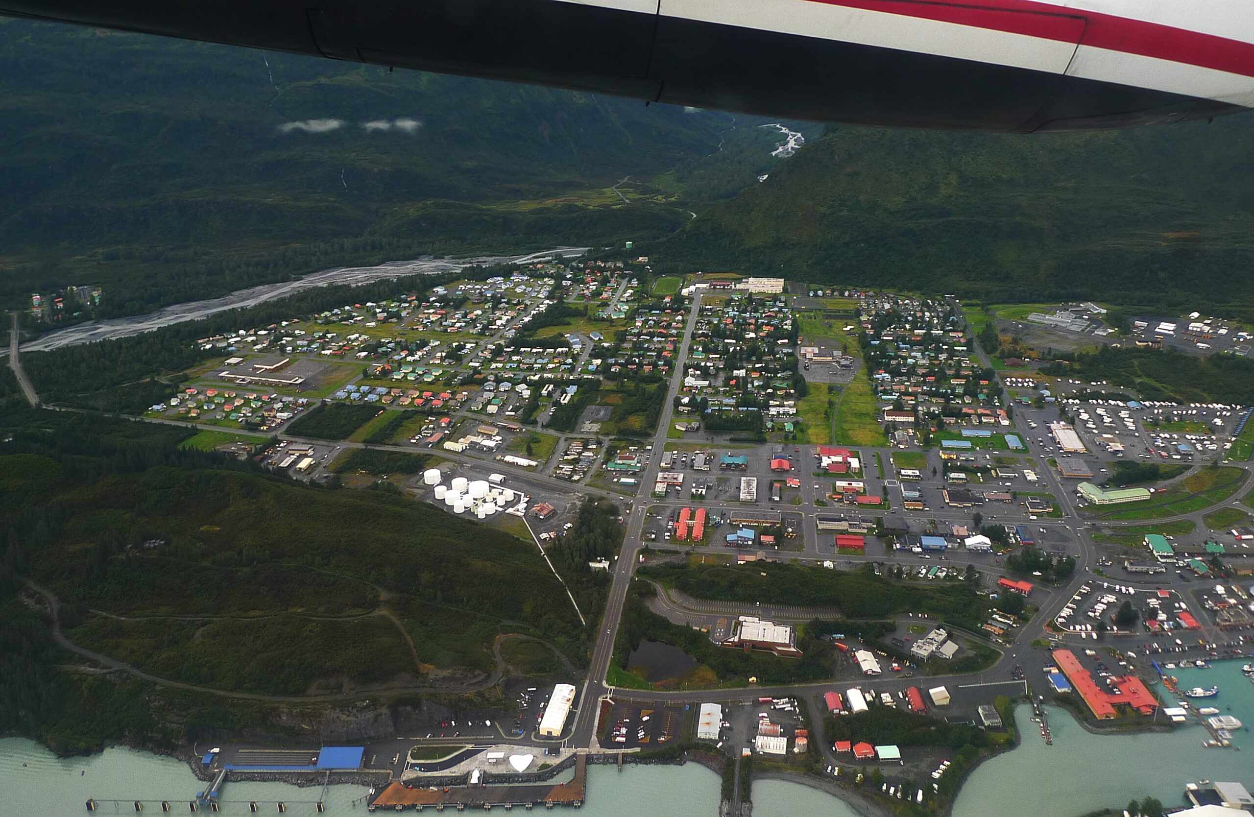 a town can be seen from an aerial view out of a plane