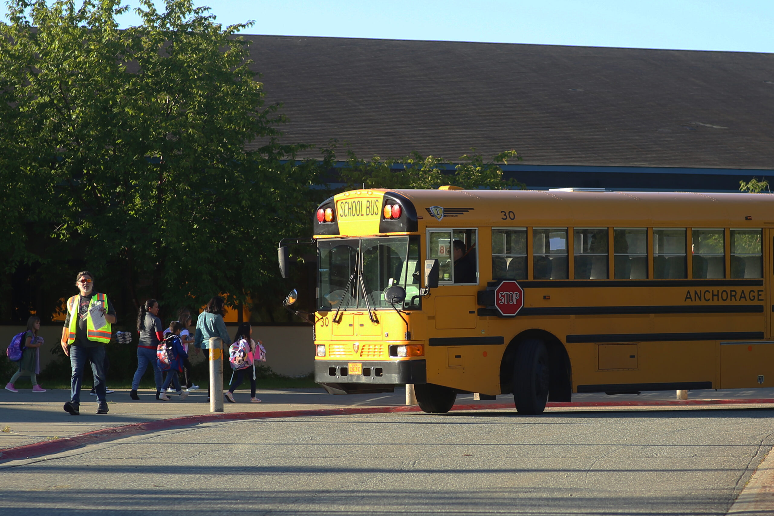 Students Exit School bus and head to school entrance
