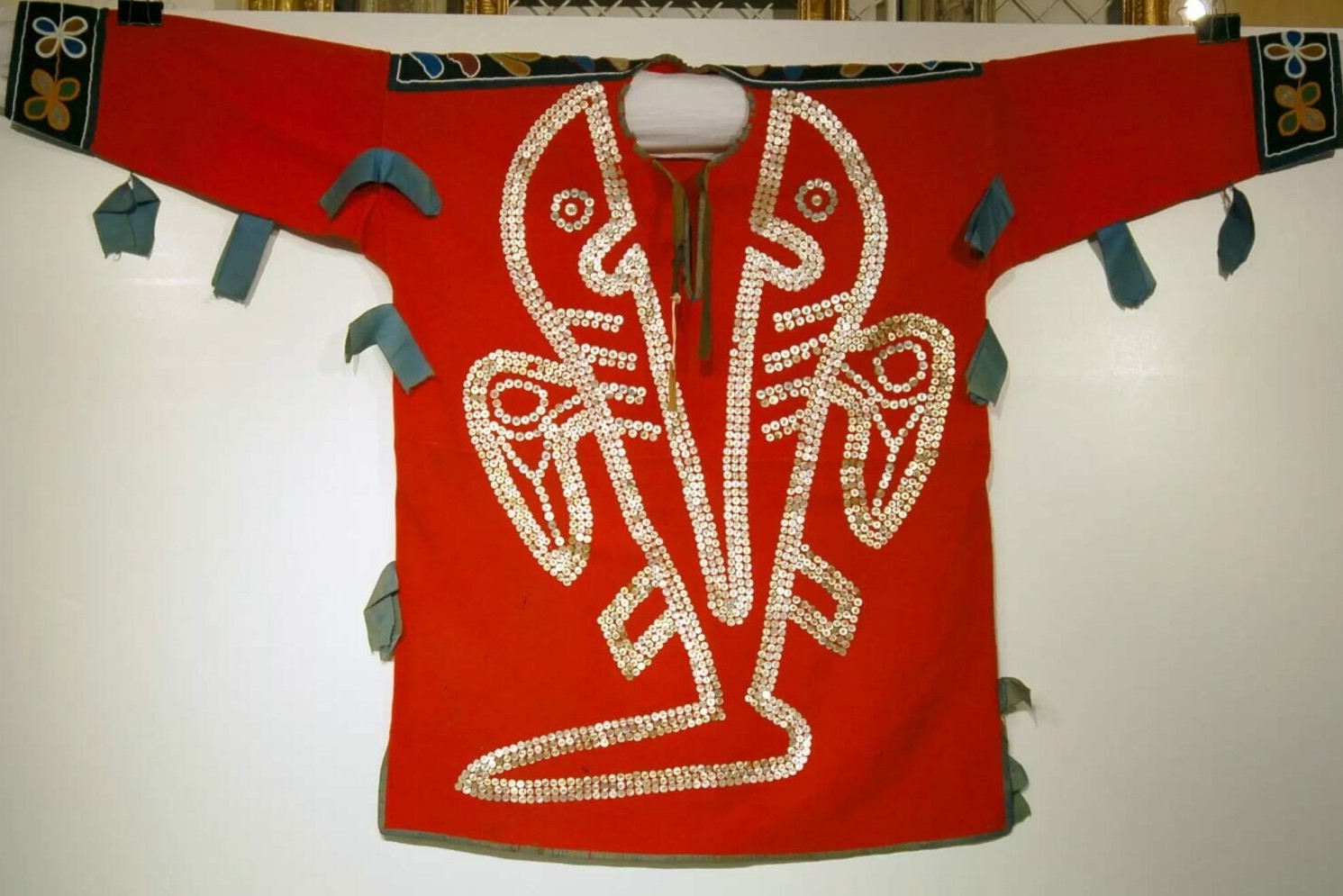 a red mudshark shirt with ornate designs