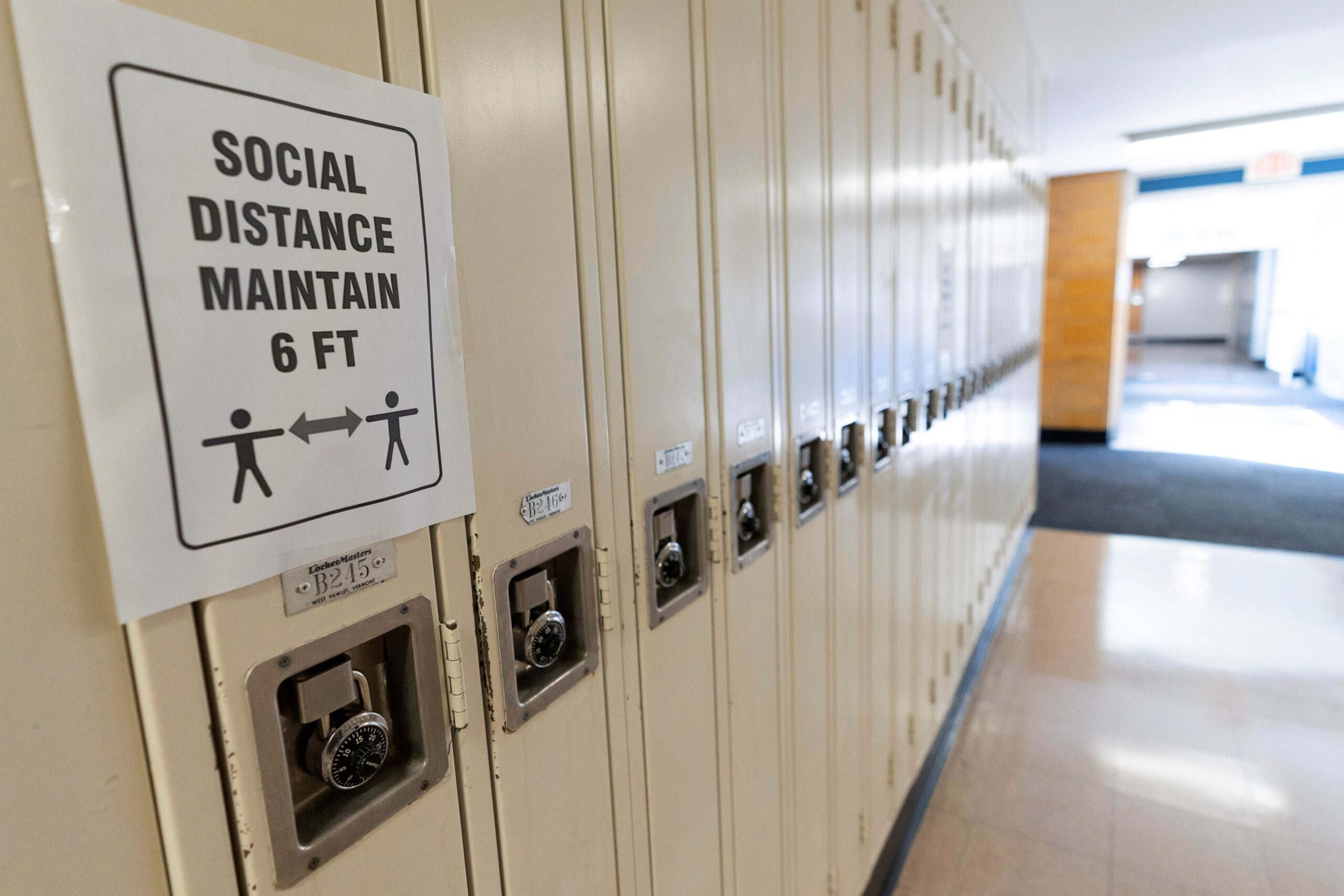 lockers, with a sign that says social distance maintain 6 ft