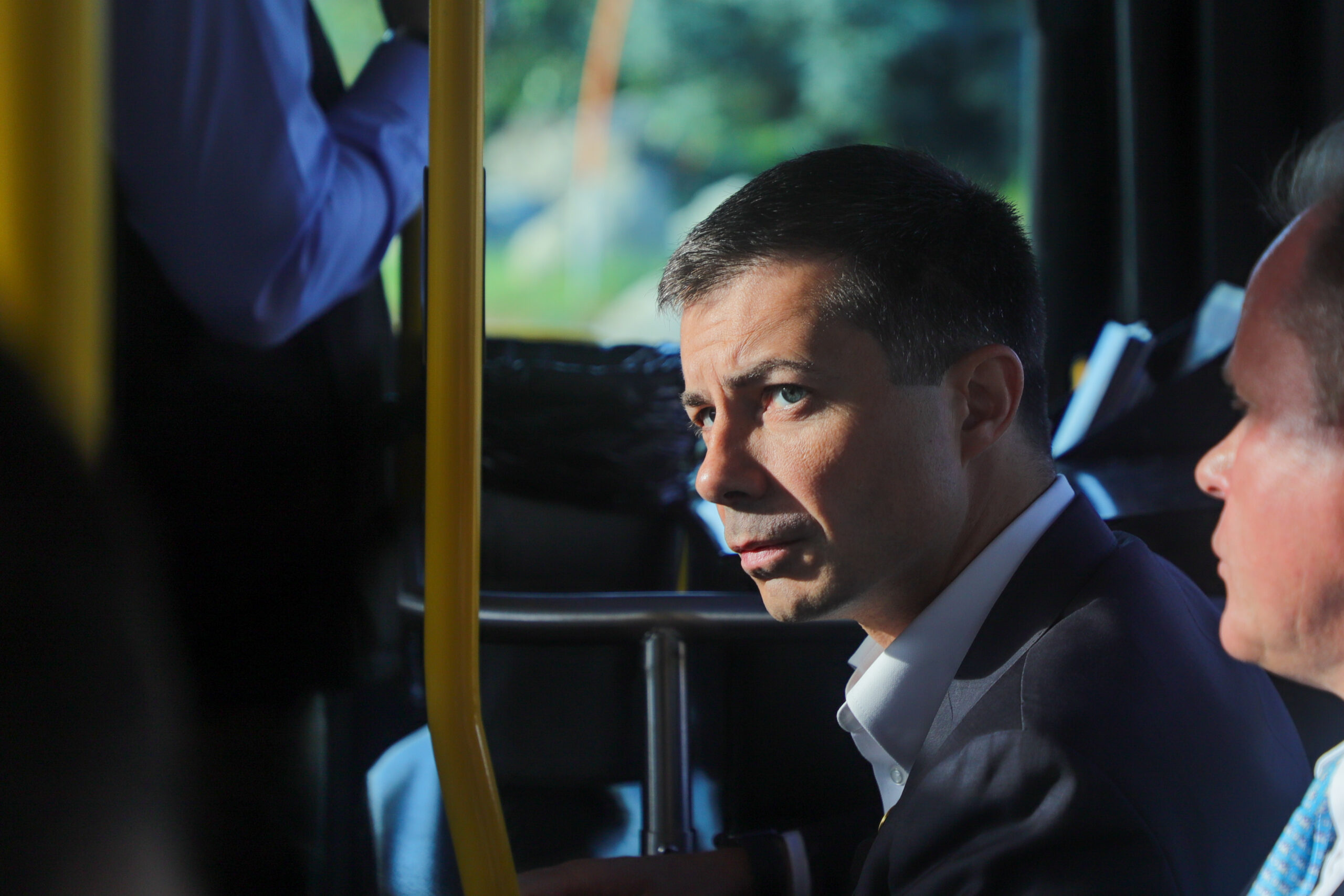 medium shot of a man sitting on a bus.
