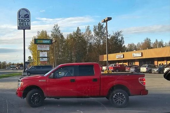 a red truck parked near a Taco bell