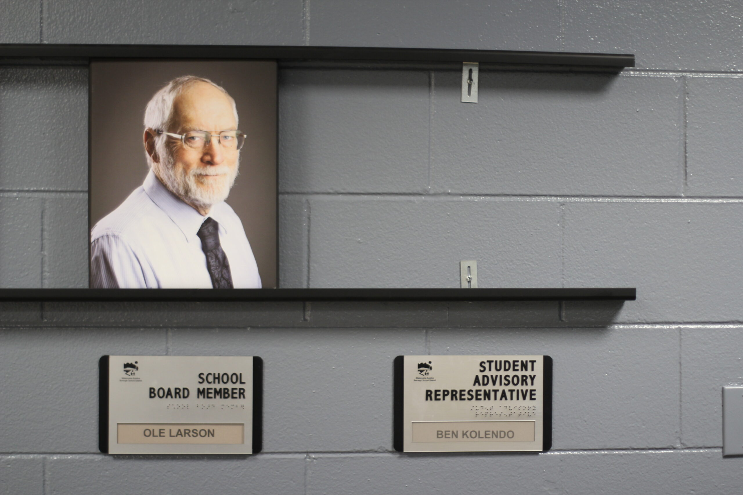 A photo of a school board member next to an empty spot where a photo of a student representative would go.