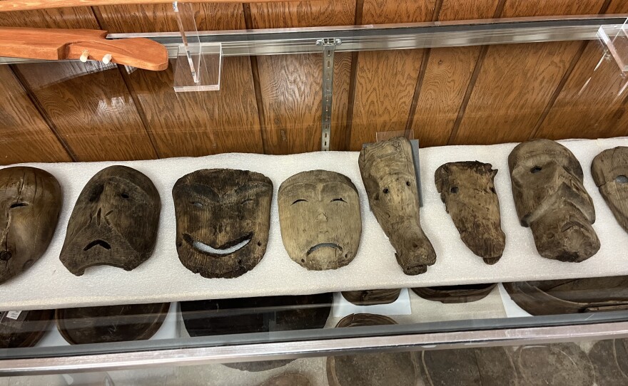 masks on display in a glass case