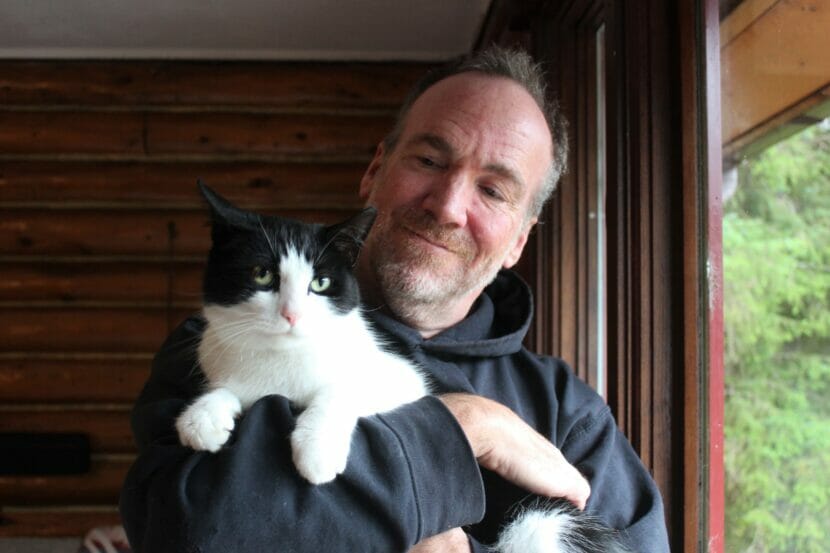 a man holds a cat