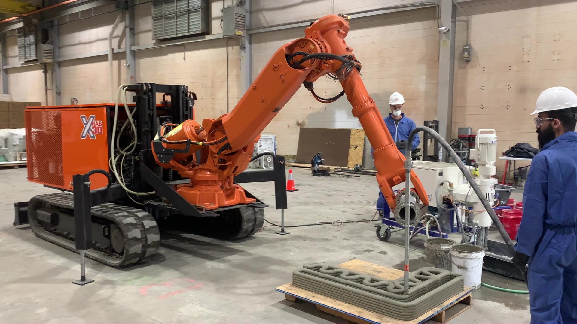 a 3D printing robot extrudes concrete