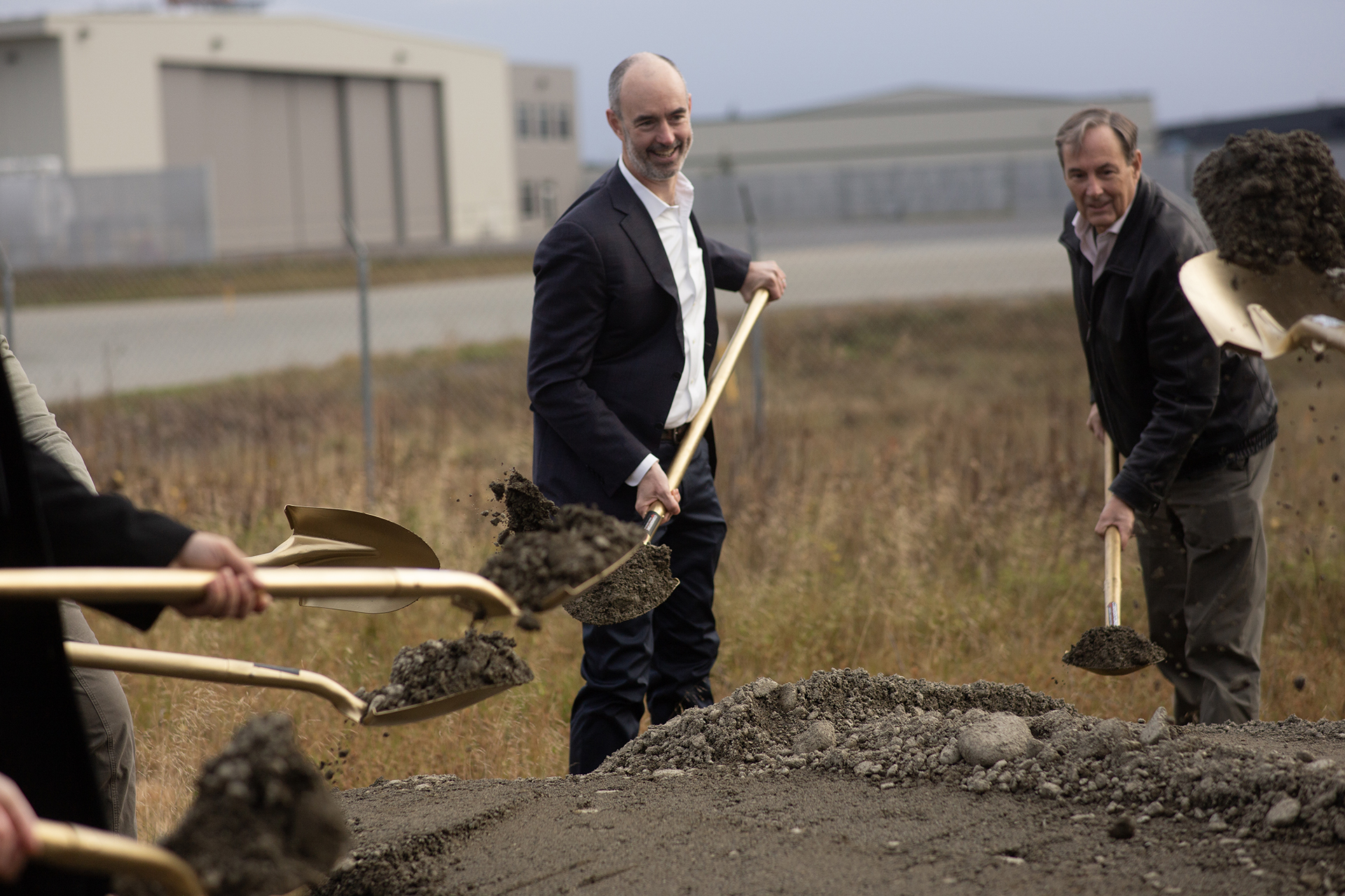 North Link Rep and guests involved in the new airport terminal throw dirt from gold shovels at the Groundbreaking ceremony Wednesday, October 11, 2023 (Shiri Segal/Alaska Public Media)