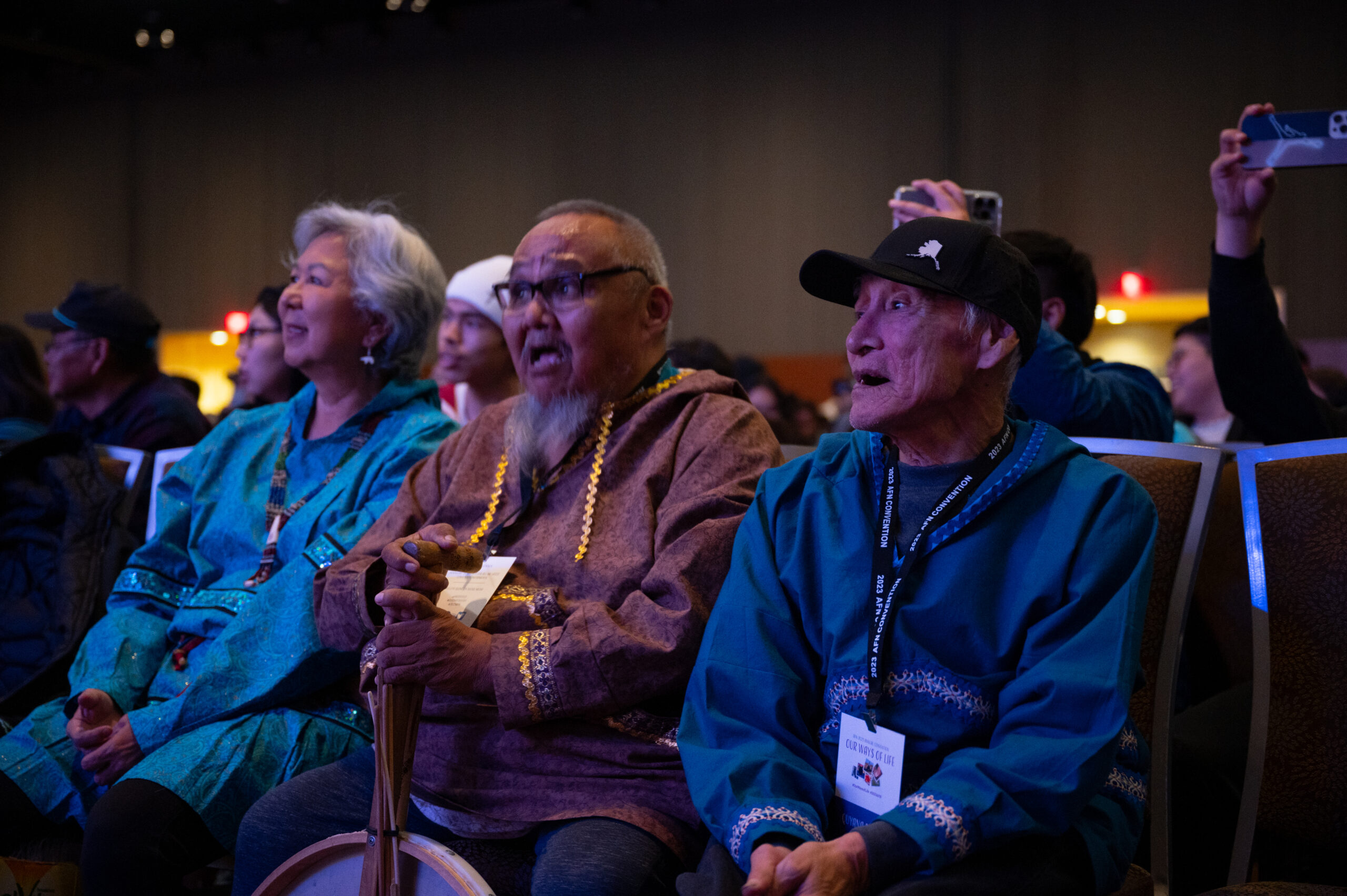 A group of elders singing along to a show.