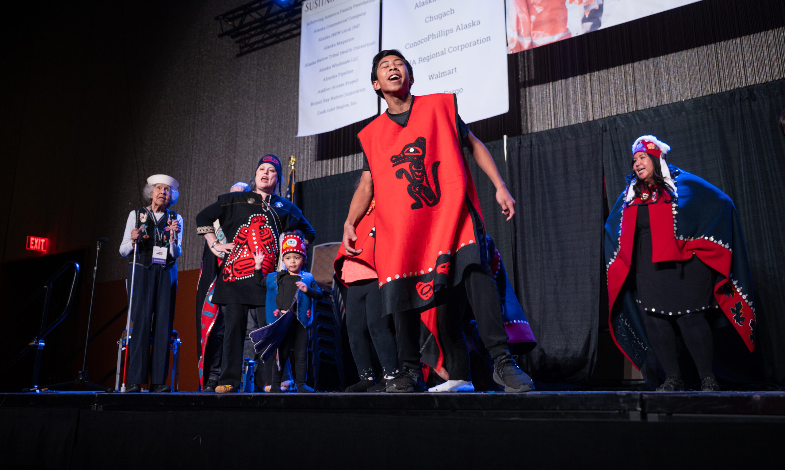 A group of tlingit dancers on stage.
