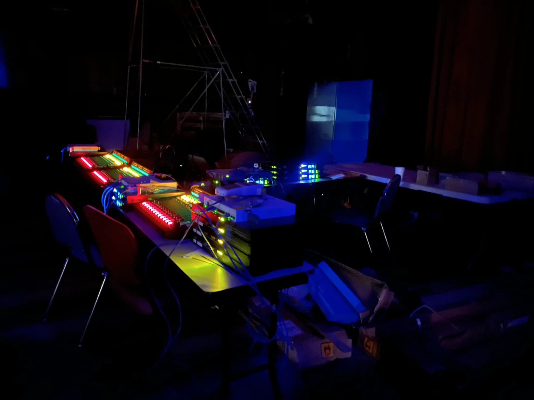 Colored computer lights in a dark studio.
