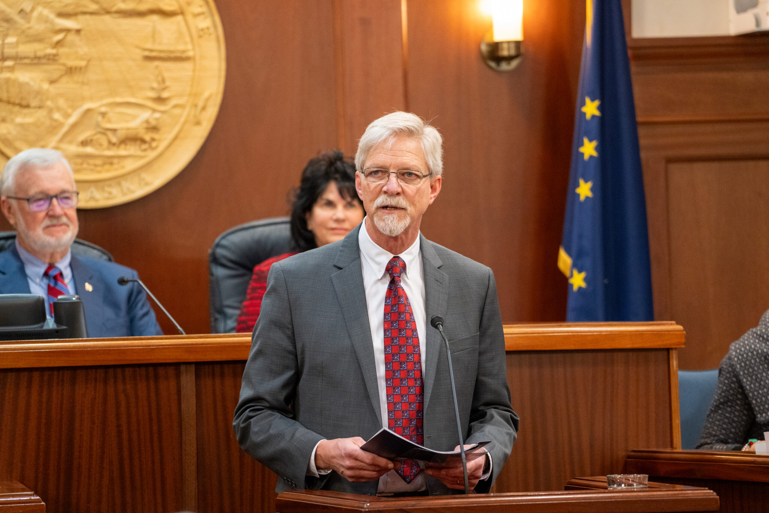 Man speaking in legislative chamber