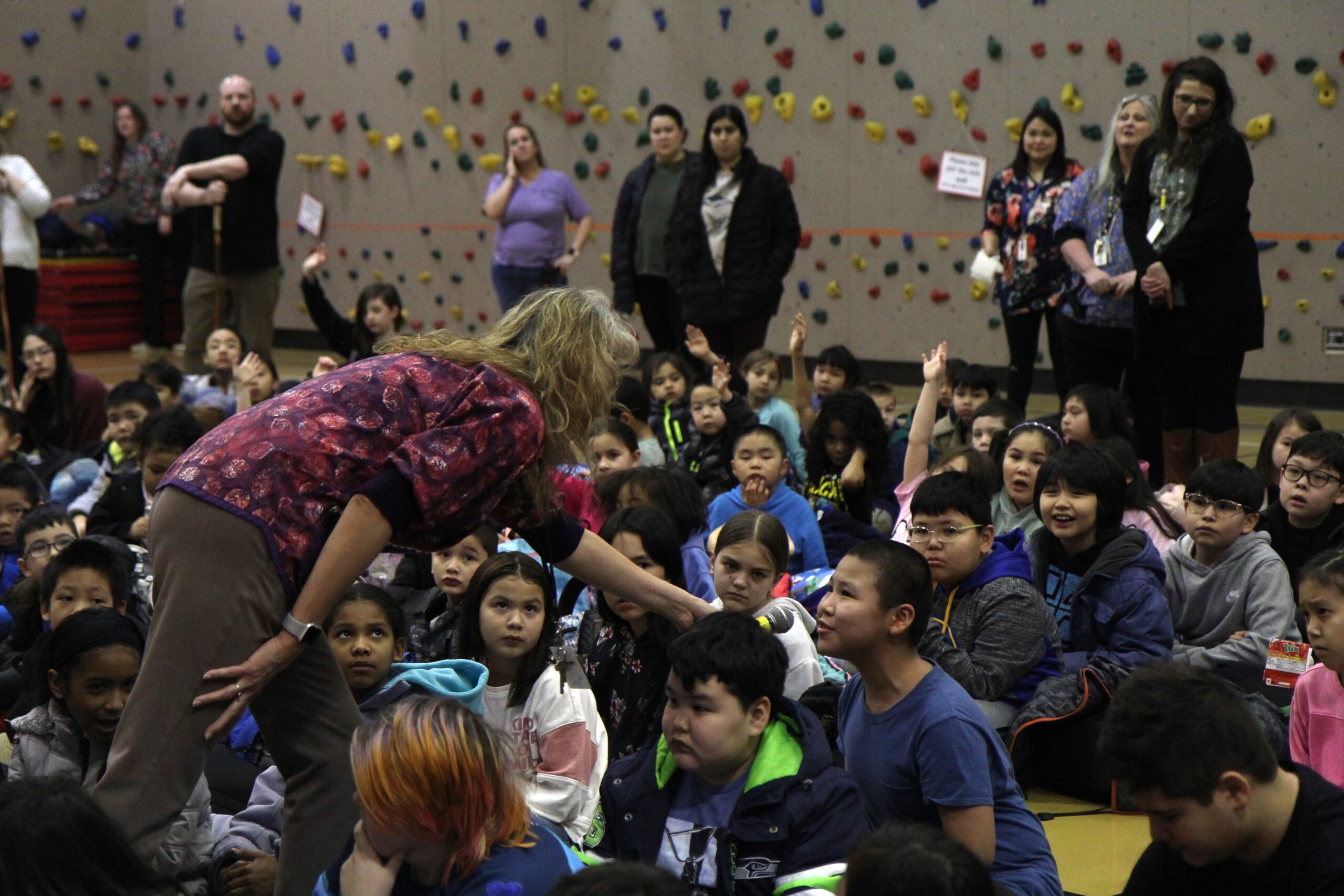 Alaska Native Cultural Charter School Principal Sheila Sweetsir asks a student a question during the morning assembly on Feb. 20, 2024.
