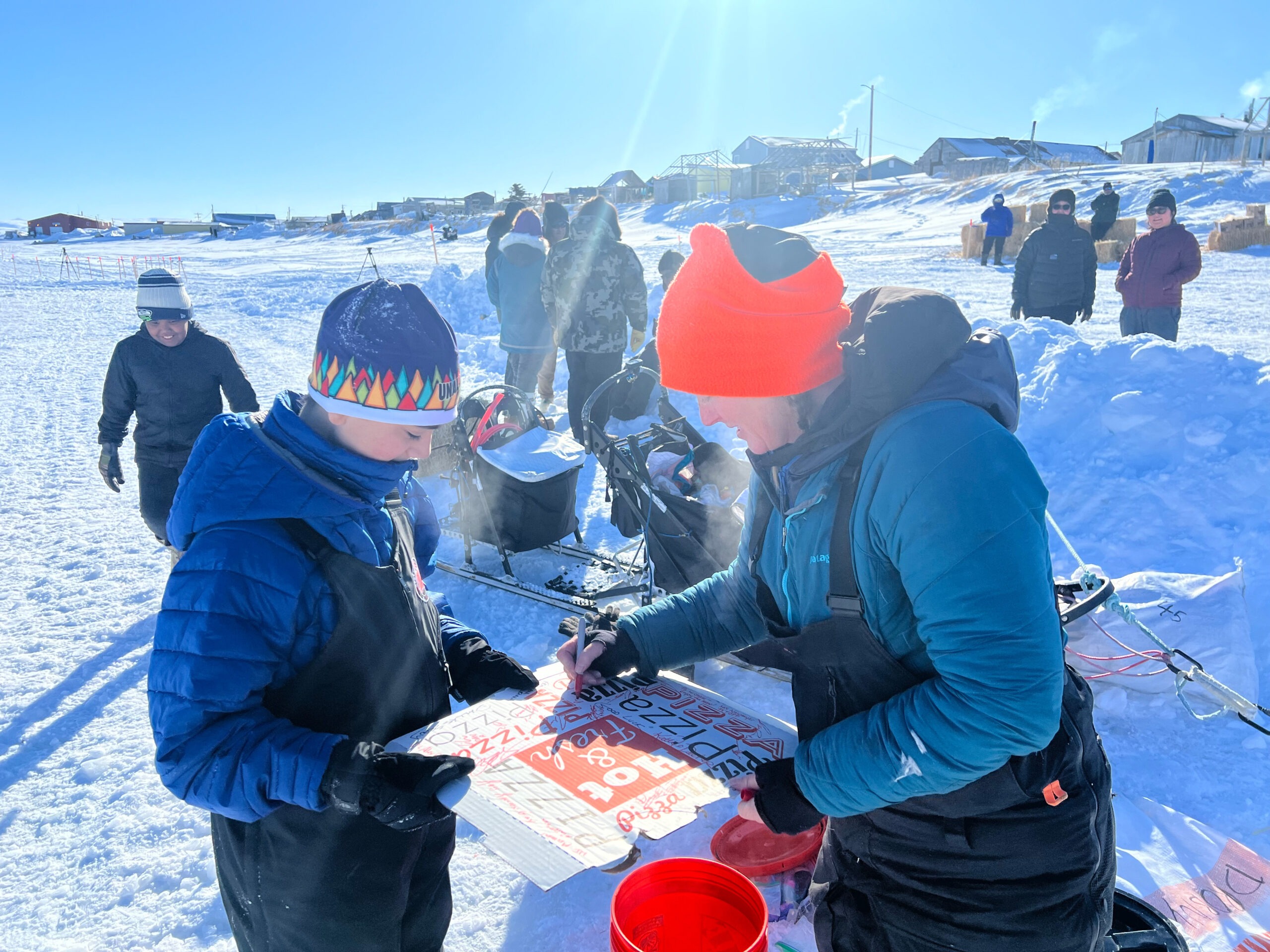 a musher signs a pizza box
