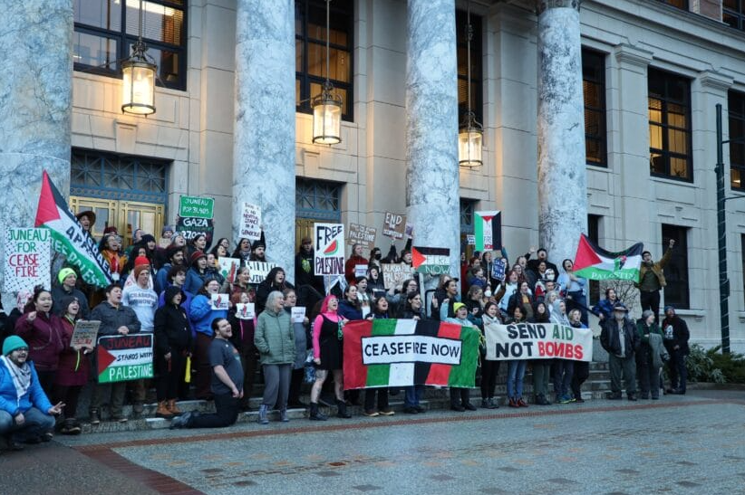 A crowd of protestors gather in front of the Alaska Capitol in Juneau.