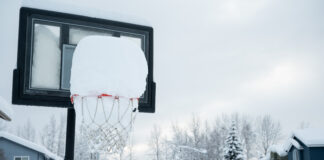 A basketball hoop full of snow