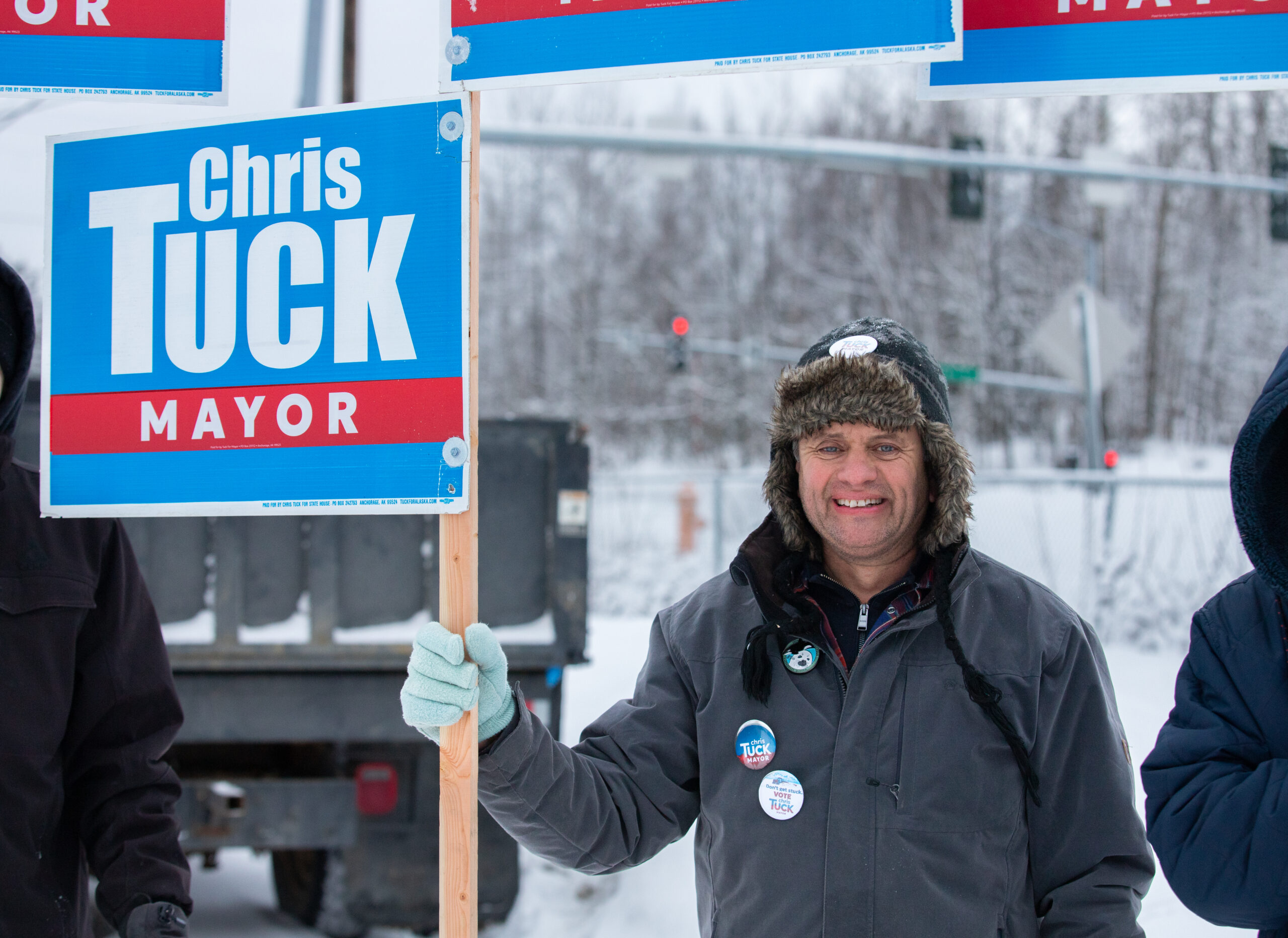 a man with a sign that says Chris Tuck Mayor