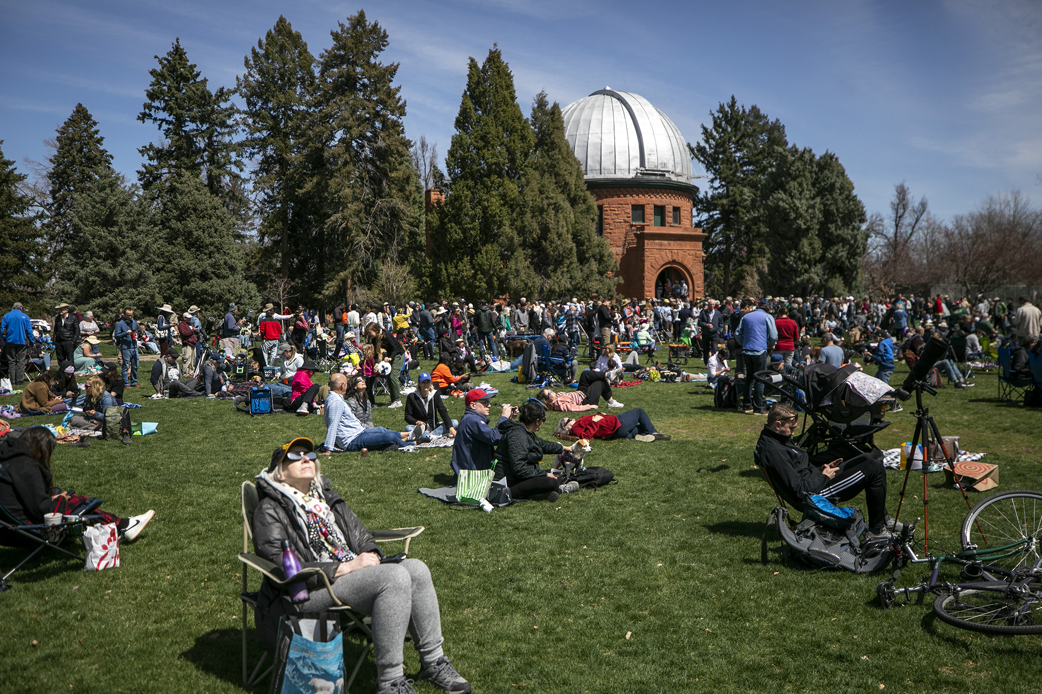 people gather outside to watch the eclipse