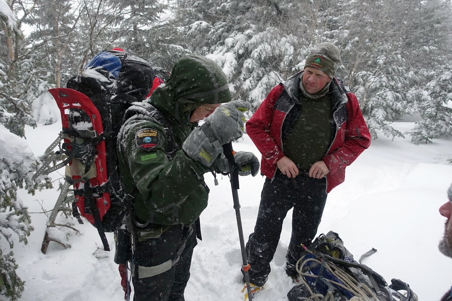 two people outside in climbing gear, in the snow