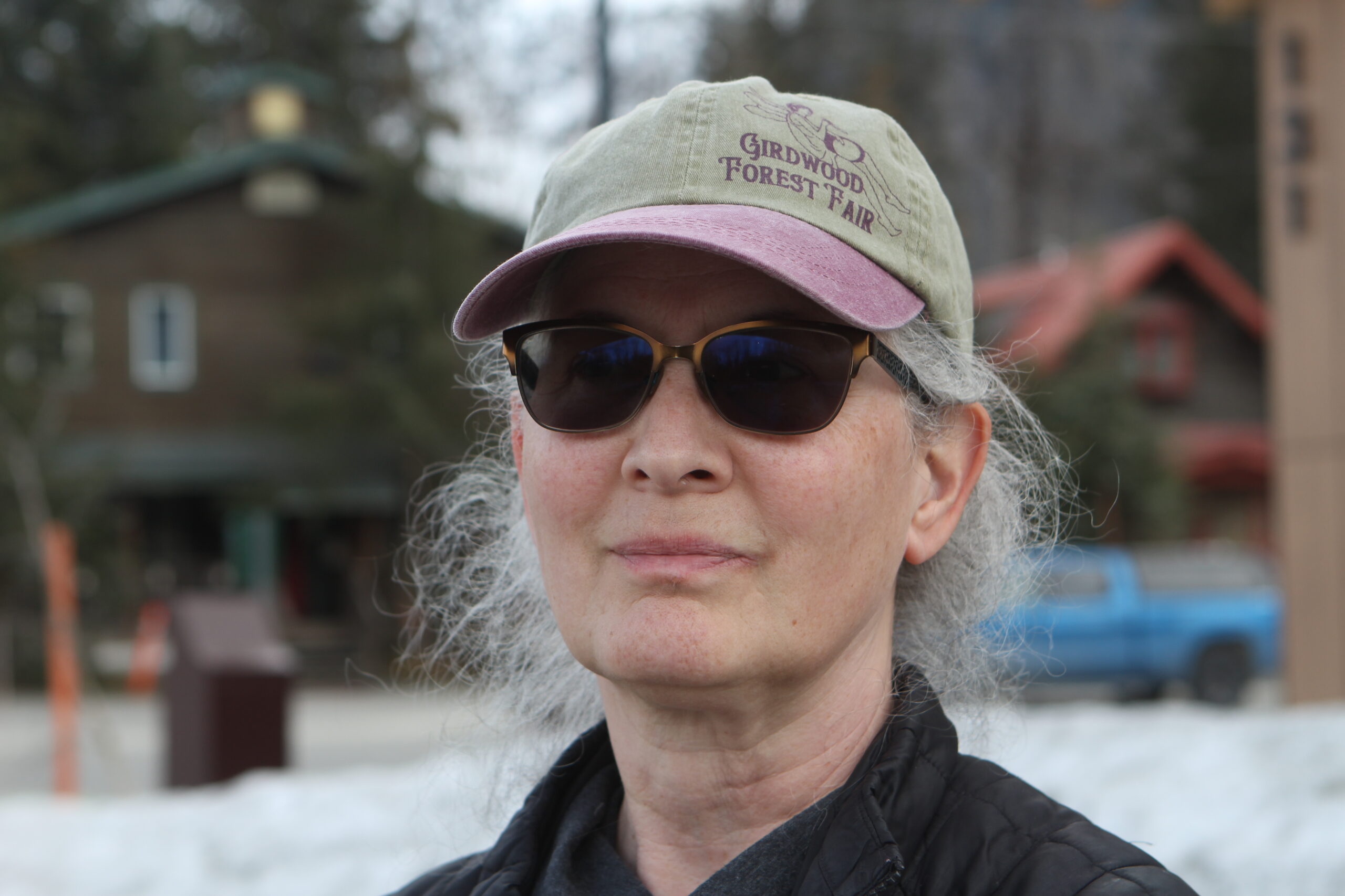 a woman in sunglasses and a baseball cap