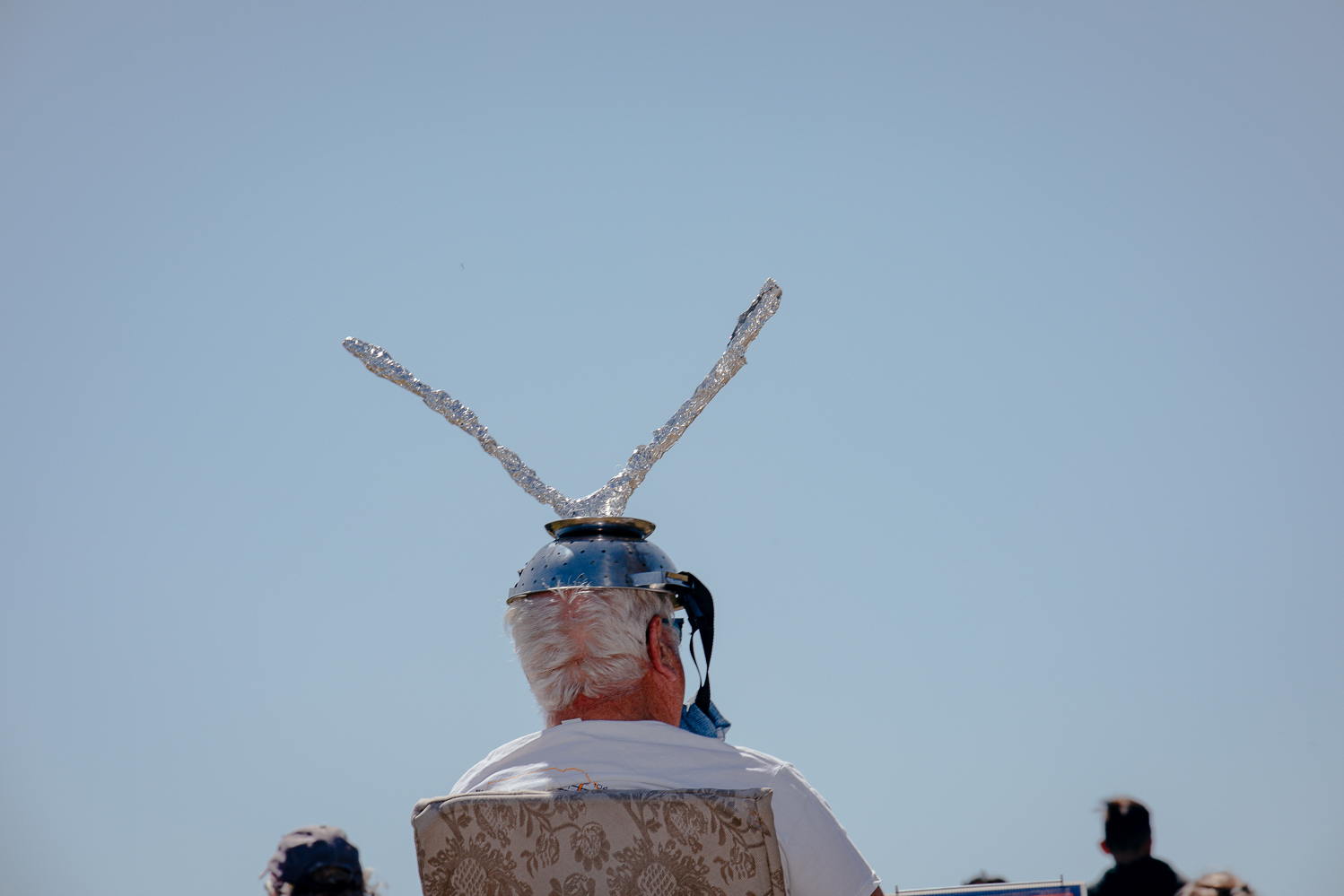 a man with a pair of makeshift antennas on his head