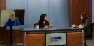 Rep. Cathy Tilton speaks to Lori Townsend, while both sit at a desk. Sen. Gary Stevens appears on a TV monitor next to the two.