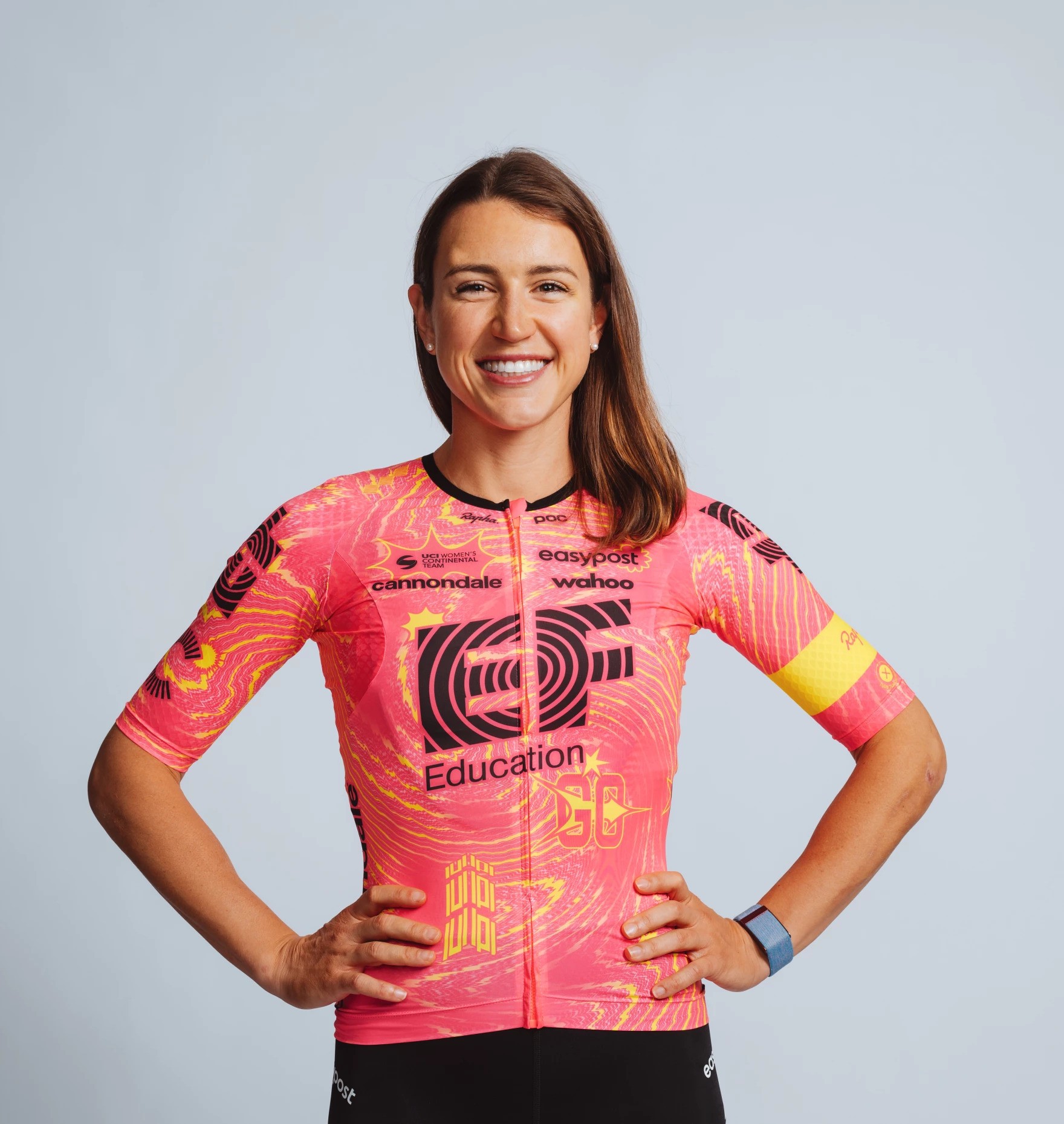 a woman in a pink bike jersey