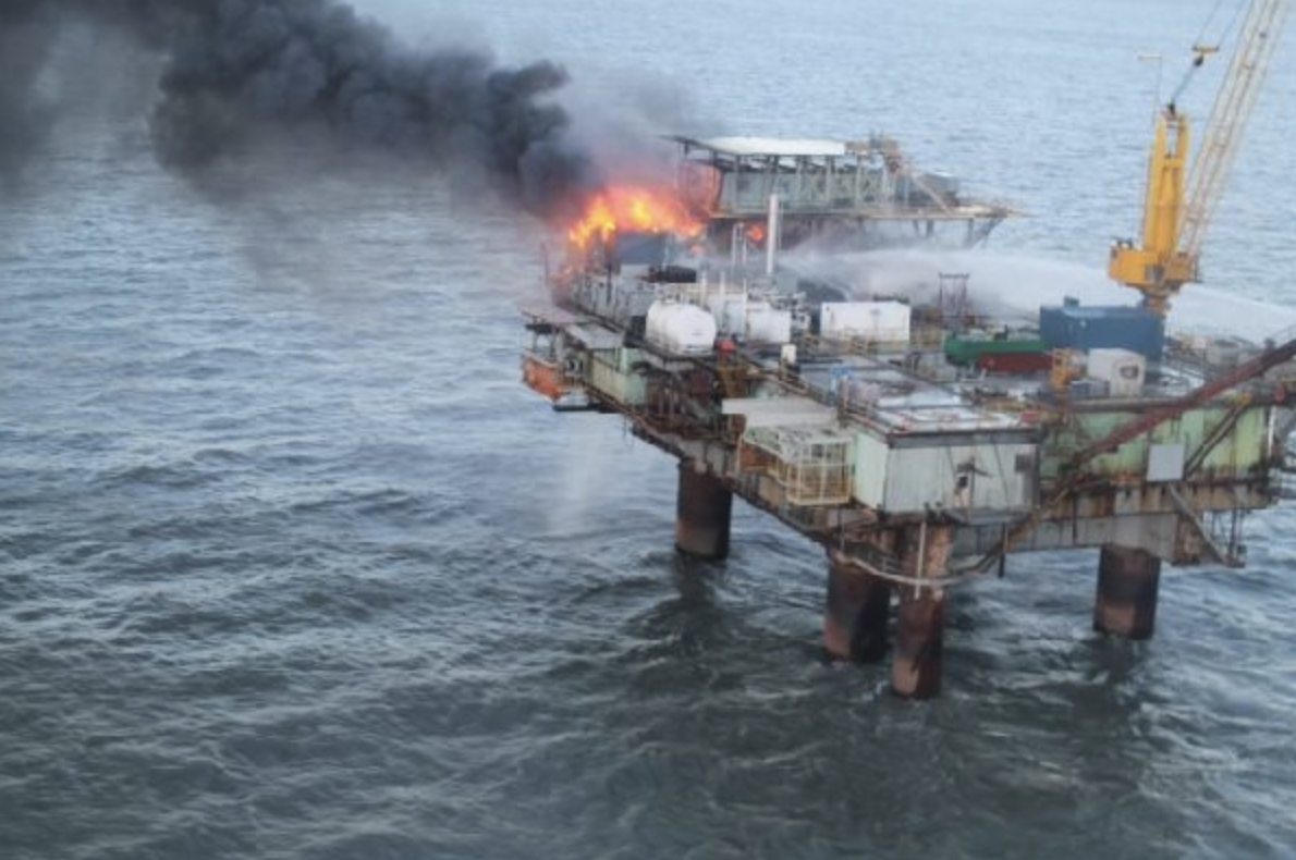 a fire on an oil and gas platform in the water