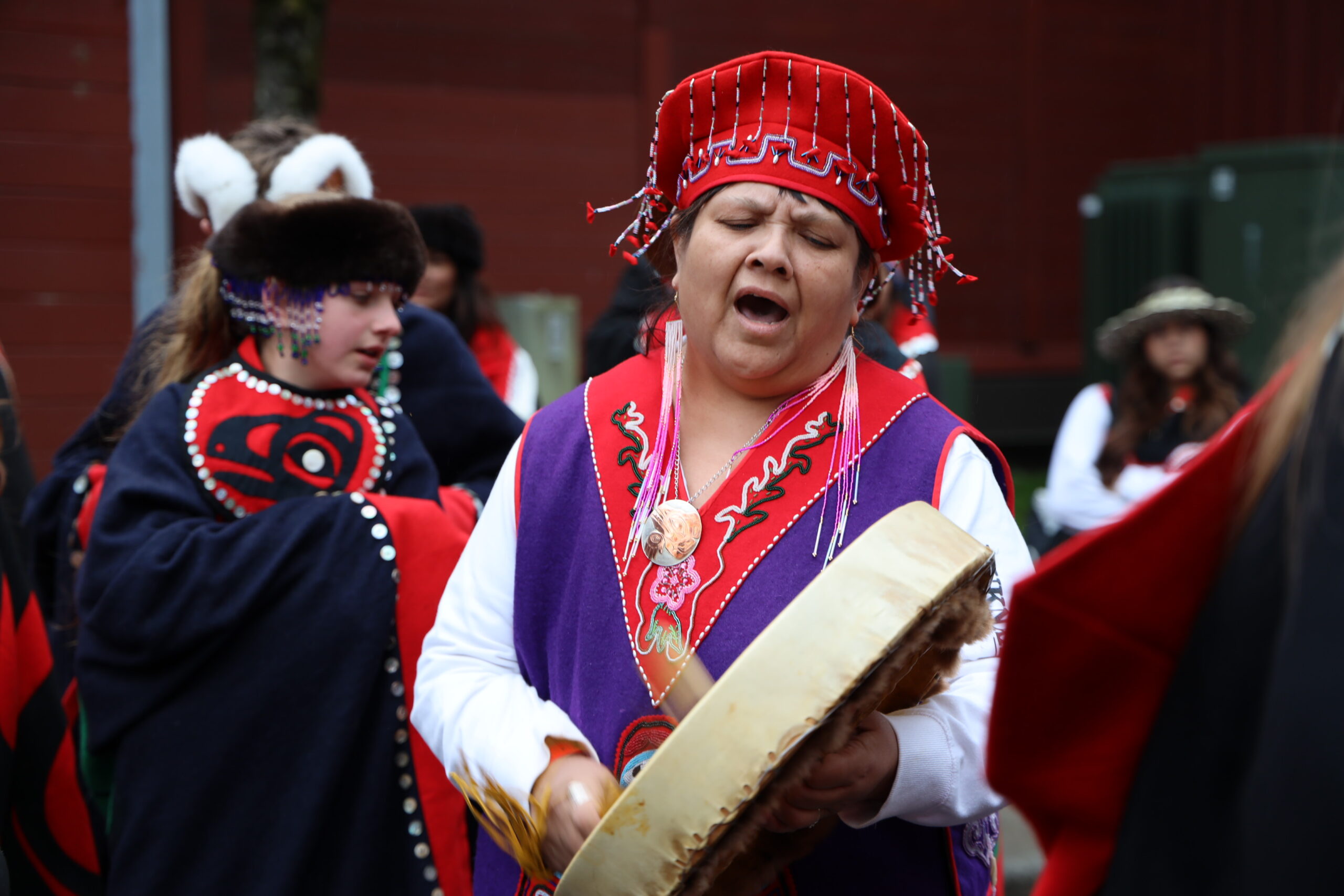 a woman drums in the street for a celebration