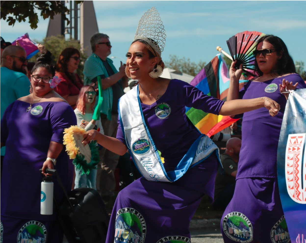 Miss Alaska Snow Queen Kaleionalani Medici Puu Lavatai dances while wearing a bright purple dress, a sash and a crown.